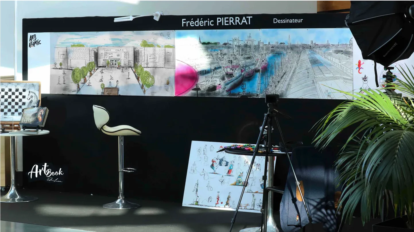 Frédéric Pierrat’s setup: a large illustrated mural, chair and live drawing equipment